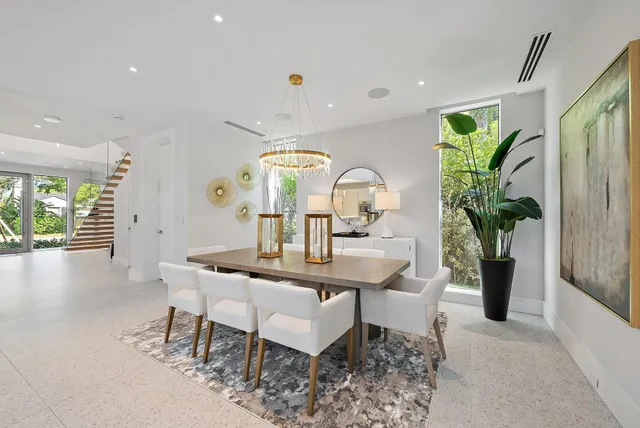 a view of a dining room with furniture and a potted plant