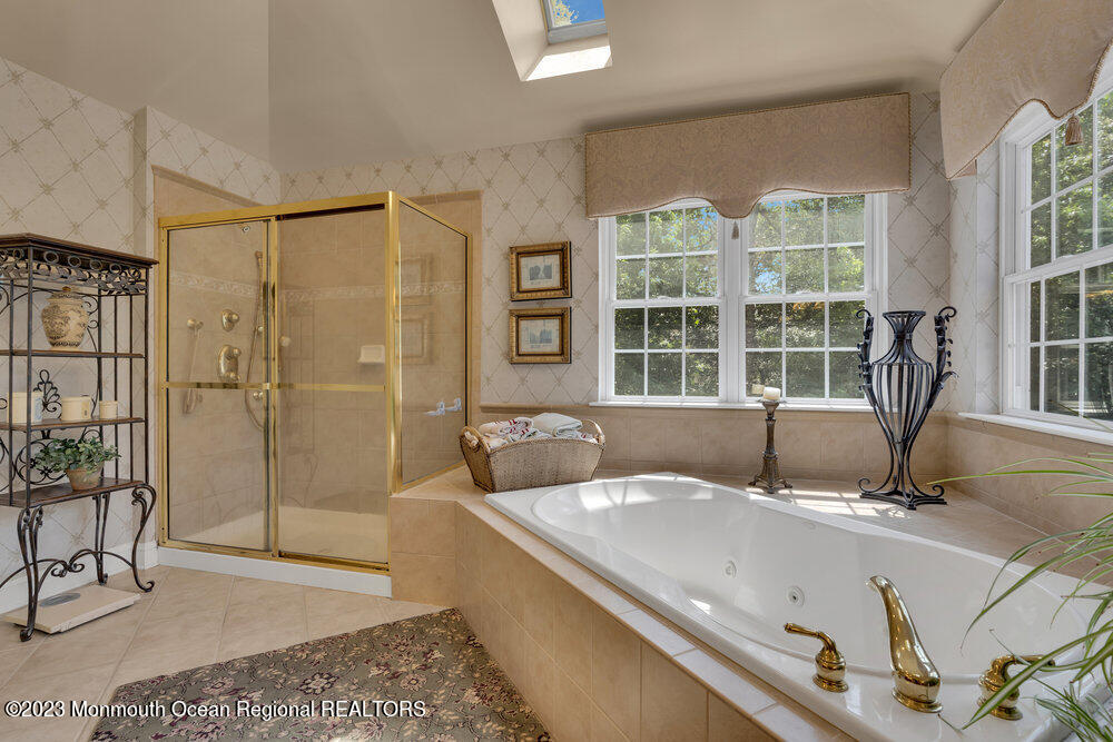 160 Butterfly Road Jackson, NJ 08527 - Photo 60 of 74 a living room with a couch and a floor to ceiling window