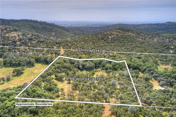 a view of a balcony with a yard