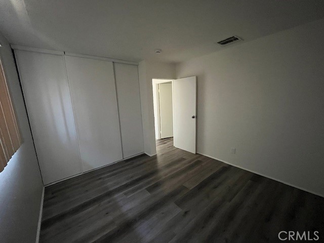 73740 Santa Rosa Way, Unit C Palm Desert, CA 92260 - Photo 16 of 18 a view of an empty room and wooden floor