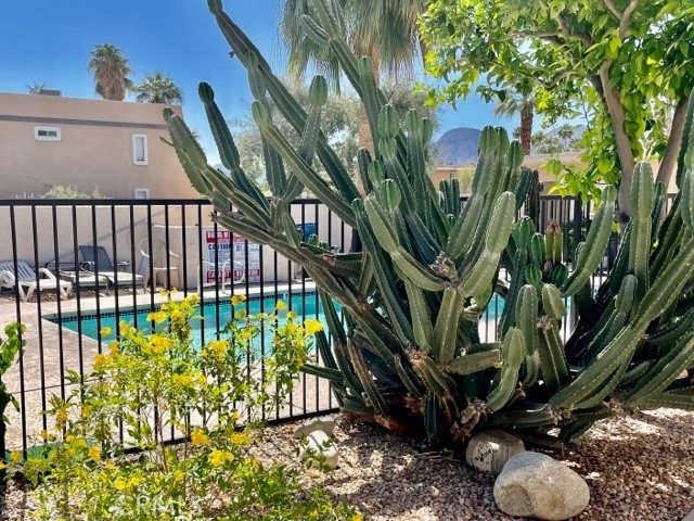 73740 Santa Rosa Way, Unit C Palm Desert, CA 92260 - Photo 17 of 18 a view of a backyard with plants and wooden fence