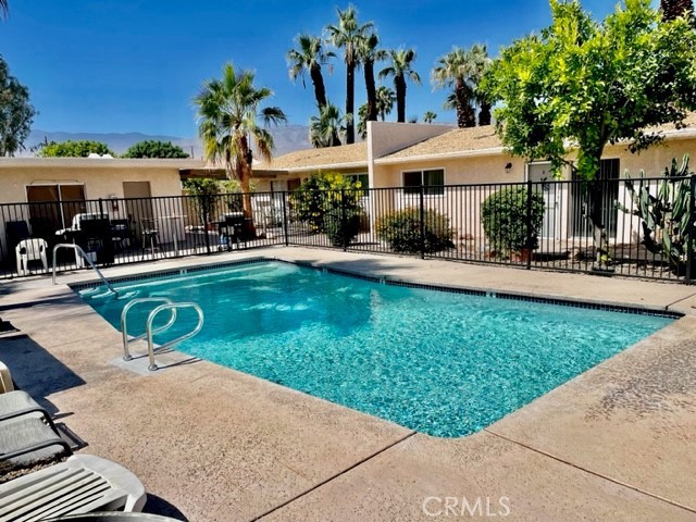 73740 Santa Rosa Way, Unit C Palm Desert, CA 92260 - Photo 2 of 18 a view of a house with swimming pool and sitting area