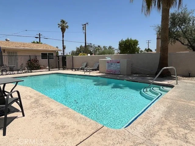 a view of a swimming pool with a lounge chairs