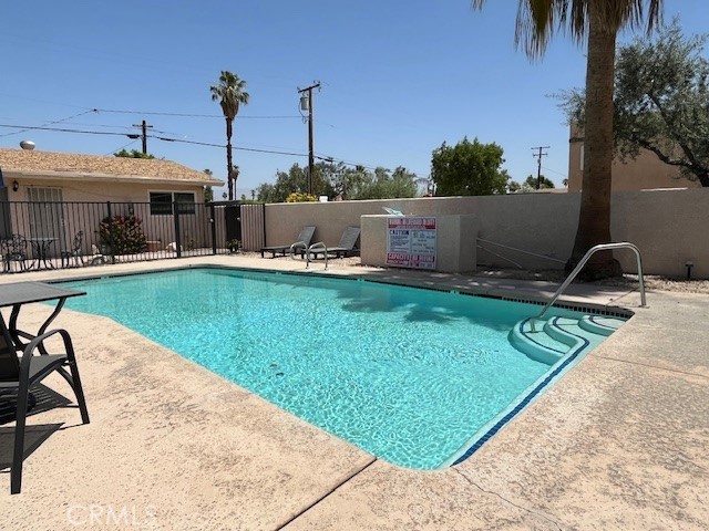 73740 Santa Rosa Way, Unit C Palm Desert, CA 92260 - Photo 3 of 18 a view of a swimming pool with a lounge chairs