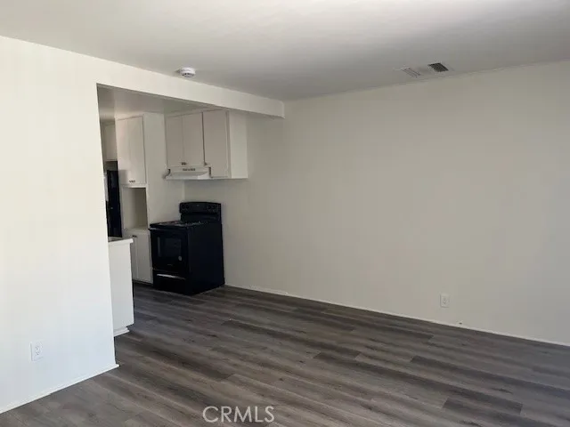 a view of an empty room with a kitchen