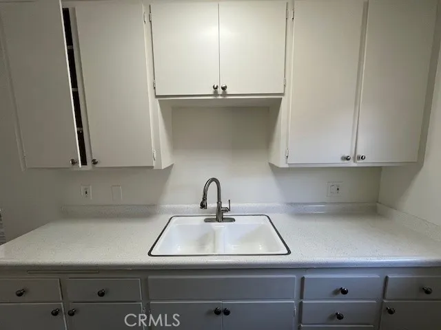 a kitchen with a sink and cabinets