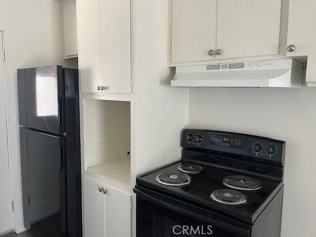 a stove top oven sitting inside of a kitchen