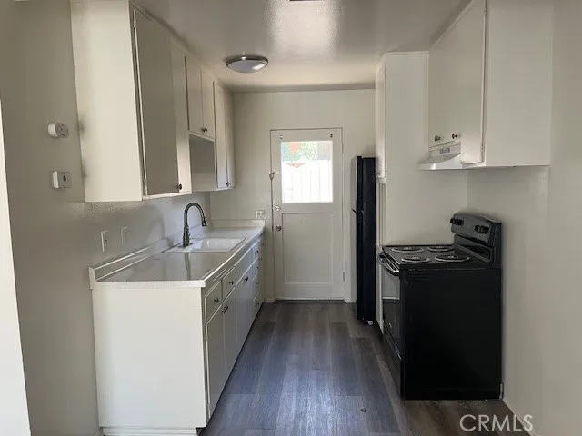a kitchen with a sink stove and refrigerator