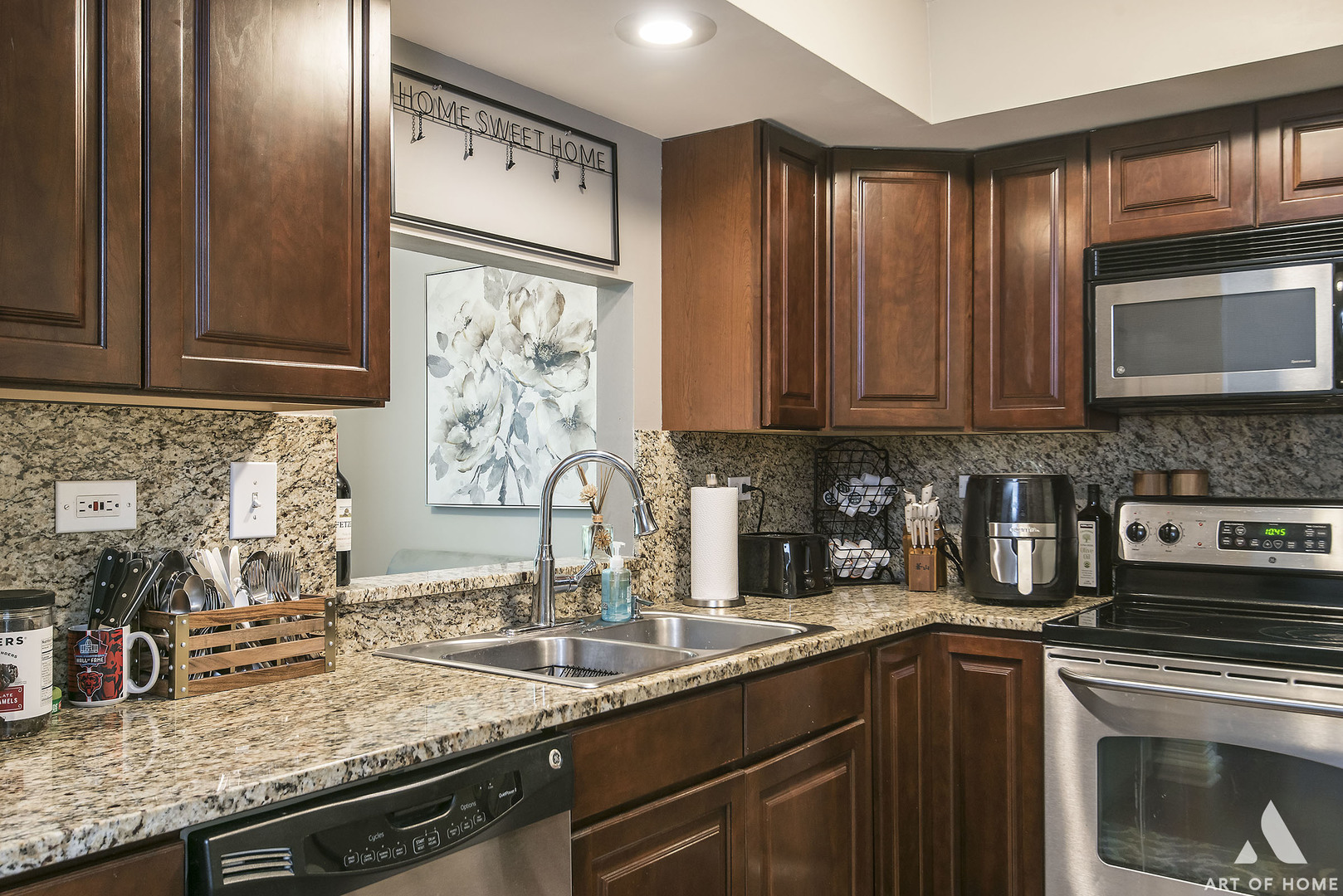 19 Foxcroft Road, Unit 131 Naperville, IL 60565 - Photo 11 of 22 a kitchen with granite countertop stainless steel appliances a stove a sink and a microwave