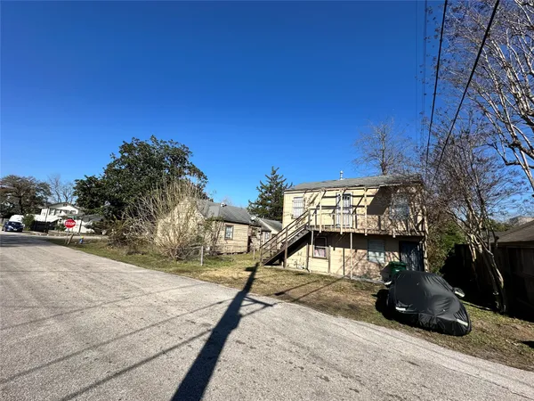 a front view of a house with a garden and yard