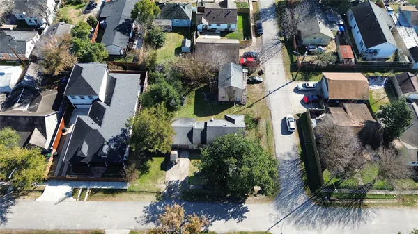 an aerial view of a house with a yard and garden
