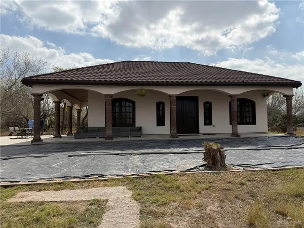 a view of a house with a iron fence