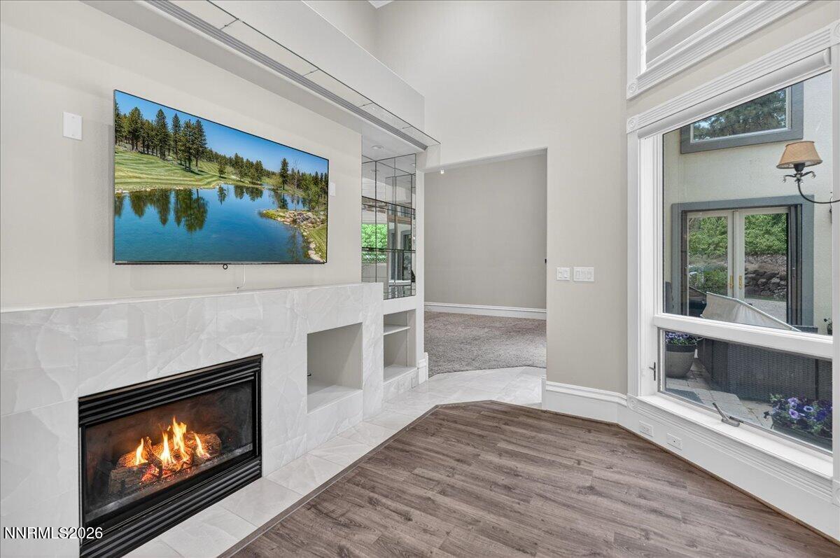 5925 Lake Geneva Court Reno, NV 89511 - Photo 50 of 84 a living room with a fireplace with a flat screen tv