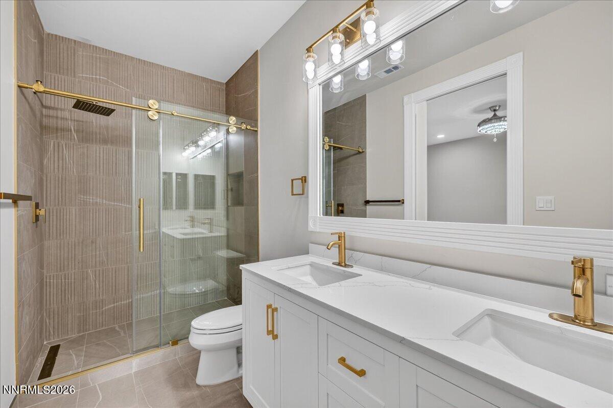 5925 Lake Geneva Court Reno, NV 89511 - Photo 63 of 84 a bathroom with a sink a toilet and shower