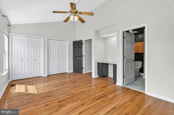 a view of empty room with wooden floor and fireplace