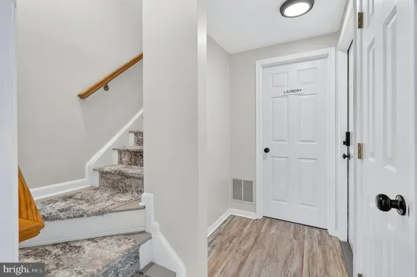 a view of a bedroom with wooden floor and staircase