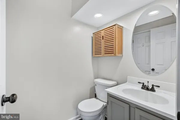 a bathroom with a sink a toilet and mirror