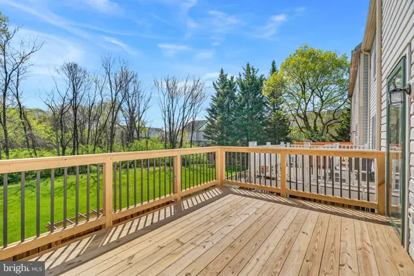 a view of balcony with wooden floor and fence