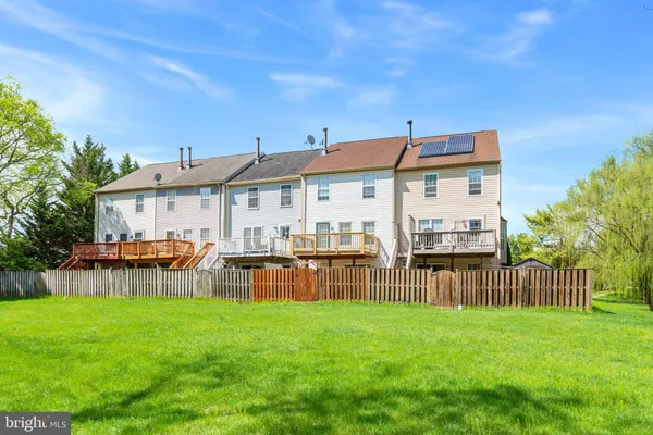a view of a house with a yard and sitting area