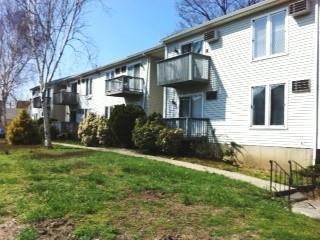 75 Kingsbury Road, Unit 10 Bridgeport, CT 06610 - Photo 1 of 1 a front view of a house with a yard and trees