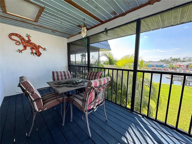 a kitchen with stainless steel appliances granite countertop a refrigerator a sink and wooden floors