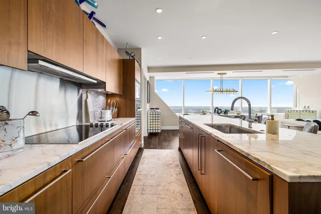 a kitchen with sink a stove and cabinets