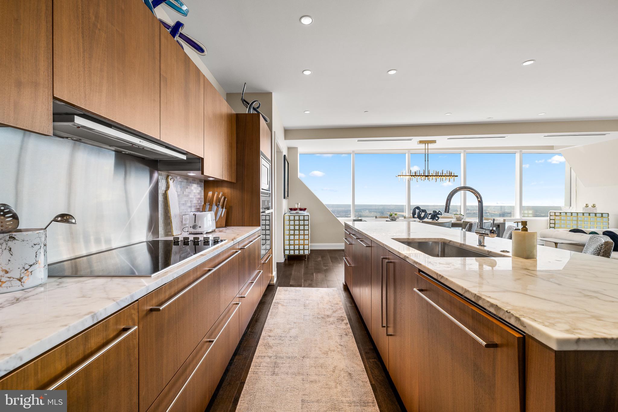 50 South 16th Street, Unit 5501 Philadelphia, PA 19103 - Photo 13 of 34 a kitchen with sink a stove and cabinets