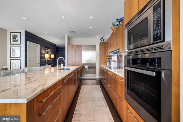 a large kitchen with stainless steel appliances double vanity and a sink