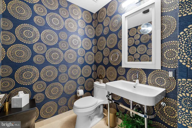 a bathroom with a toilet sink and mirror