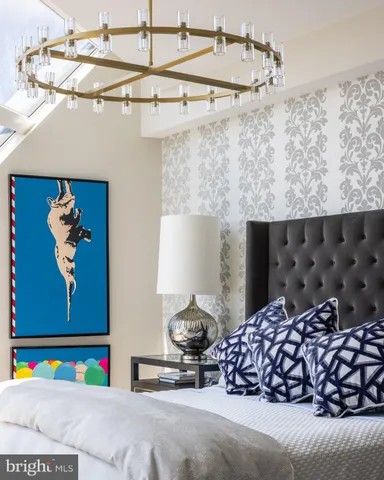 a bedroom with a bed and a painting on the wall