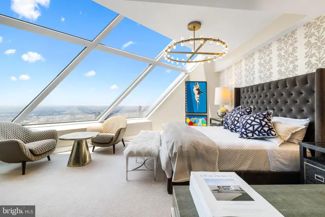 a bedroom with furniture and a chandelier