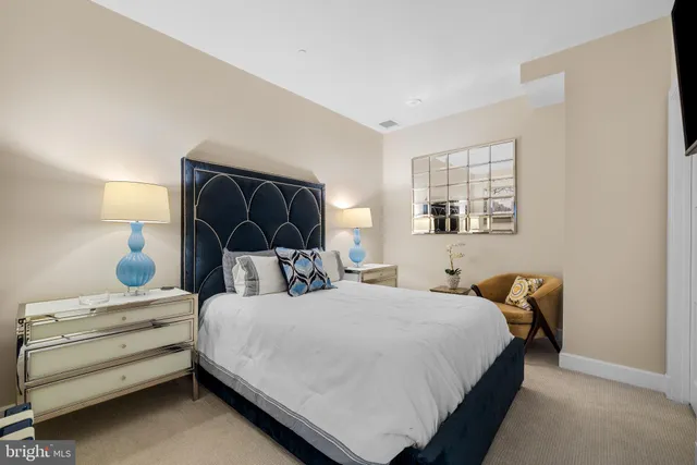 a bedroom with a bed and lamp