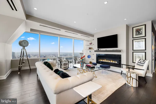 a living room with fireplace furniture and a flat screen tv