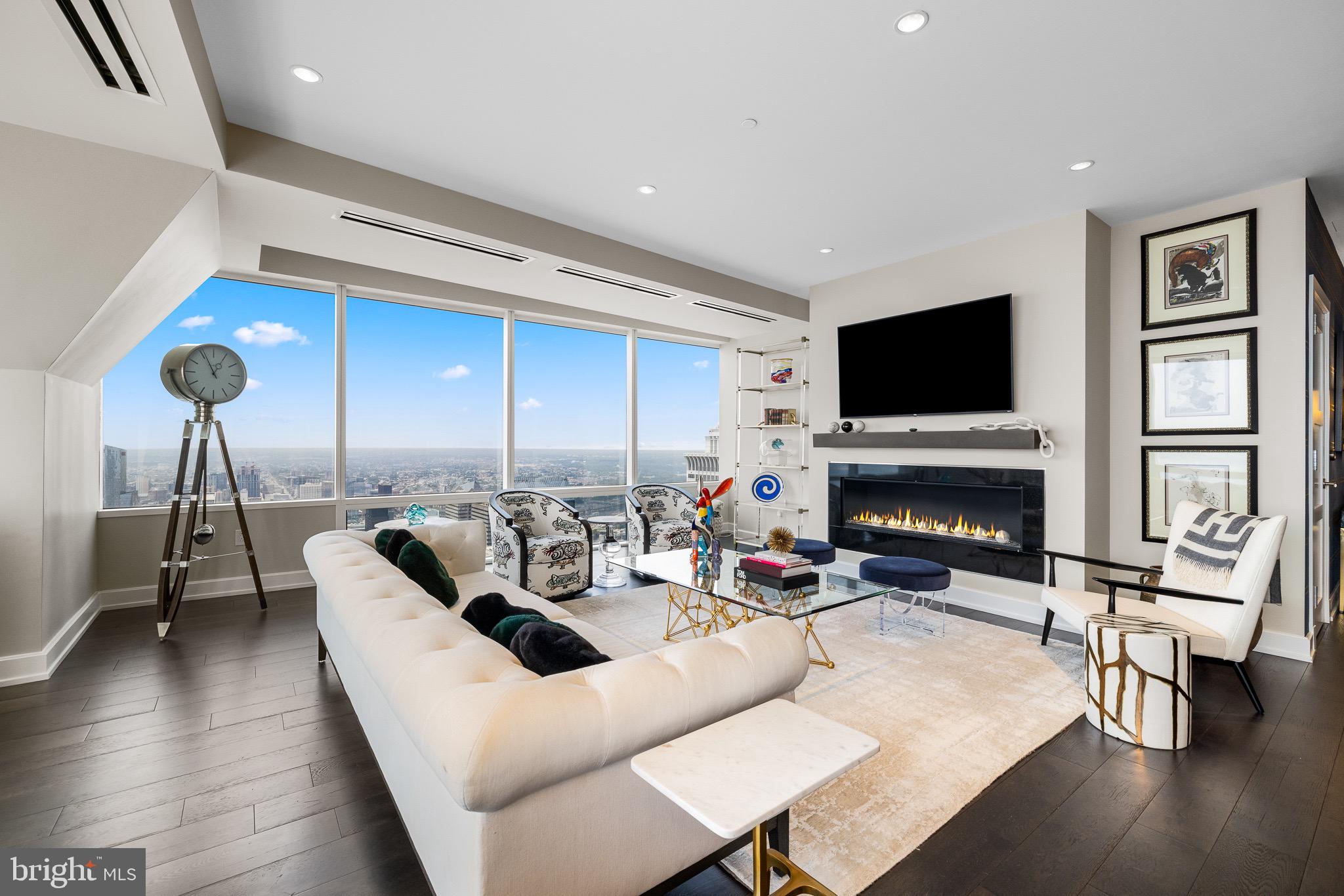 50 South 16th Street, Unit 5501 Philadelphia, PA 19103 - Photo 3 of 34 a living room with fireplace furniture and a flat screen tv