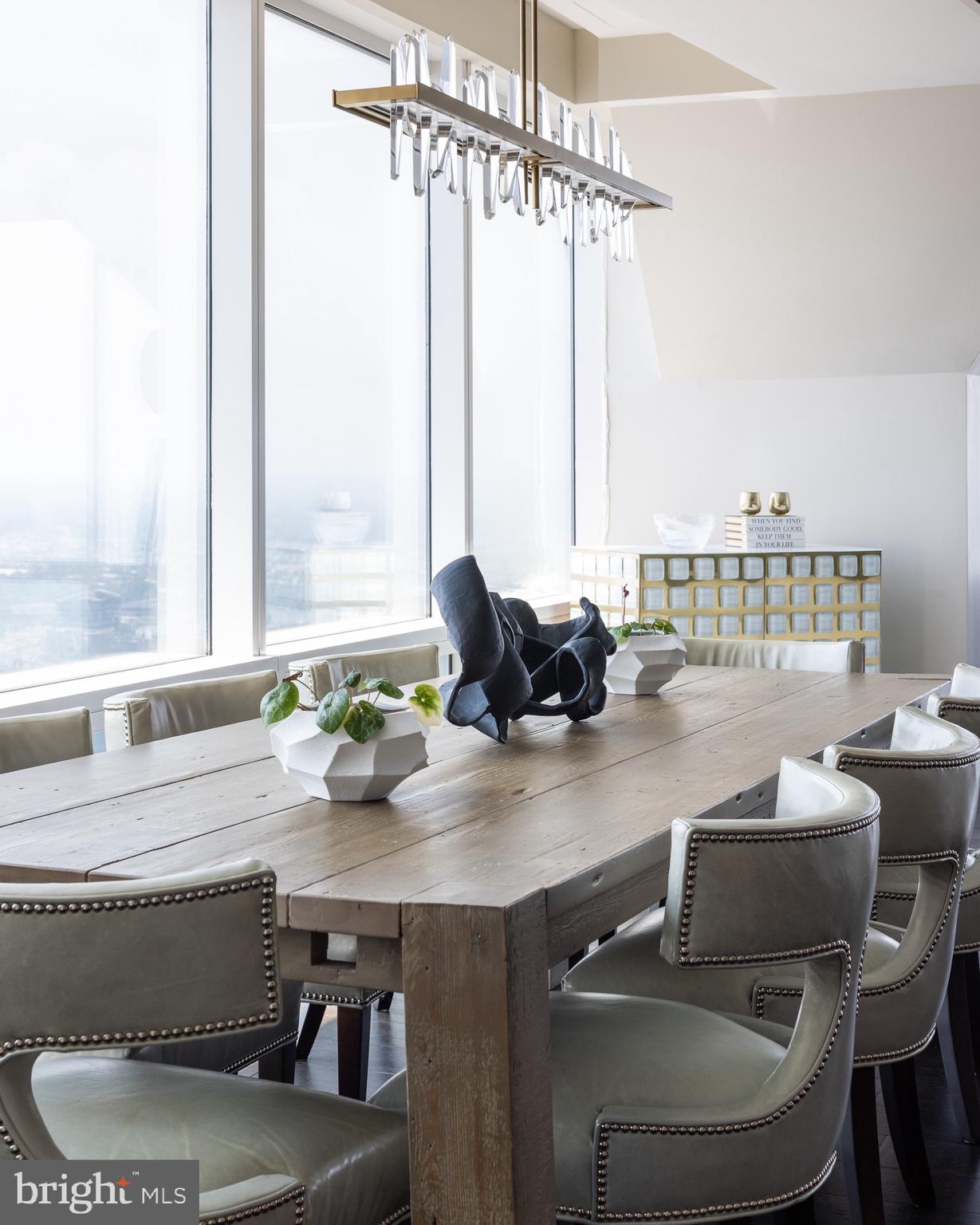 50 South 16th Street, Unit 5501 Philadelphia, PA 19103 - Photo 5 of 34 a kitchen with a table chairs stove and window