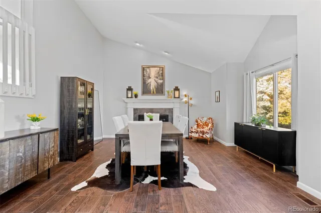a living room with furniture two window and a fireplace