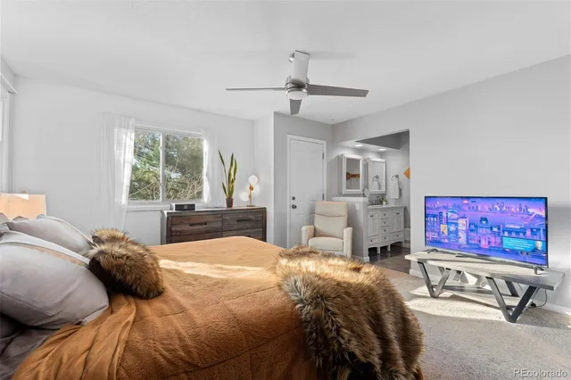 a bed room with a bed and a television