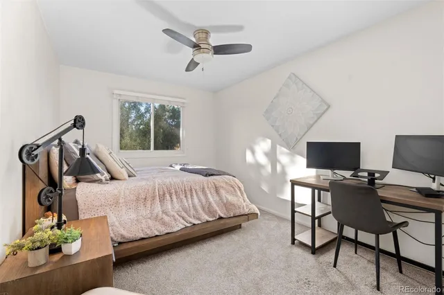 a bedroom with a bed window and potted plant
