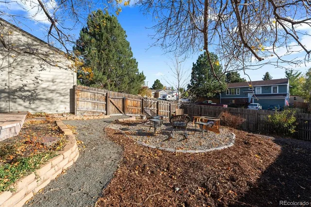 a view of backyard with swimming pool and seating space