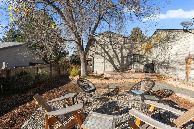 a view of a backyard with sitting area