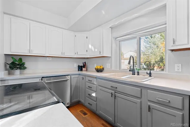a kitchen with white cabinets and white appliances