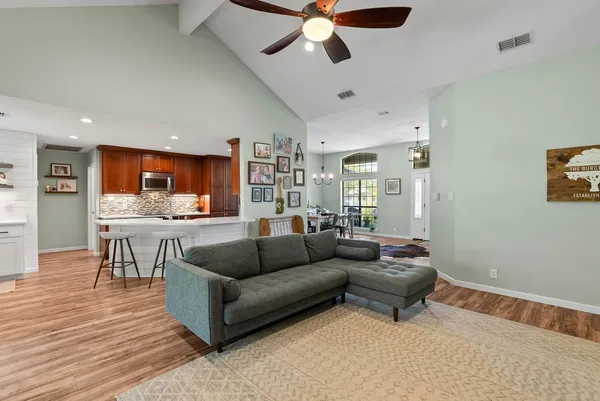 a living room with furniture and kitchen view