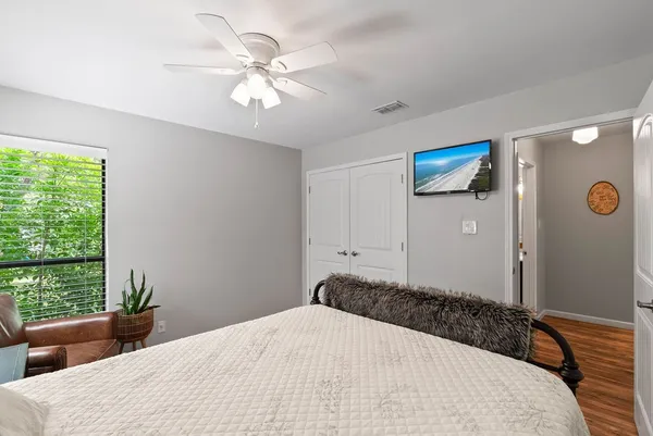 a bedroom with a large bed and a chandelier