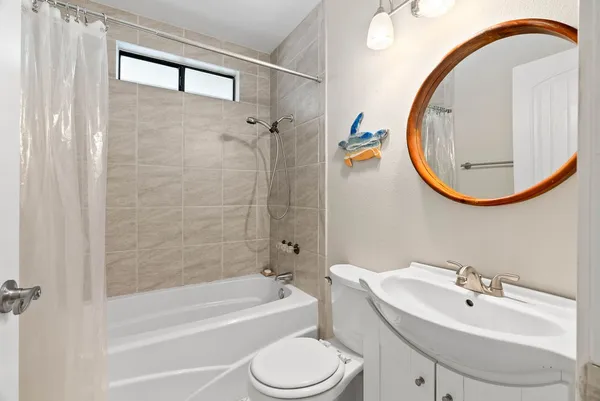 a bathroom with a sink a toilet and a mirror