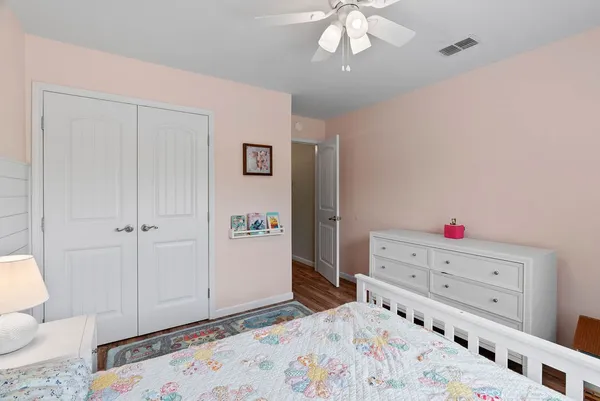 a bedroom with a bed and a dresser in it