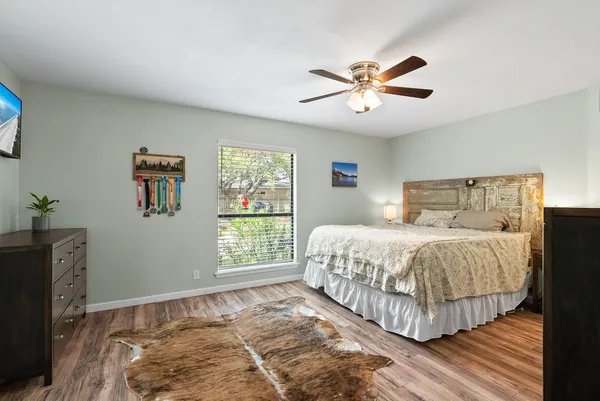 a bedroom with a large bed and a window