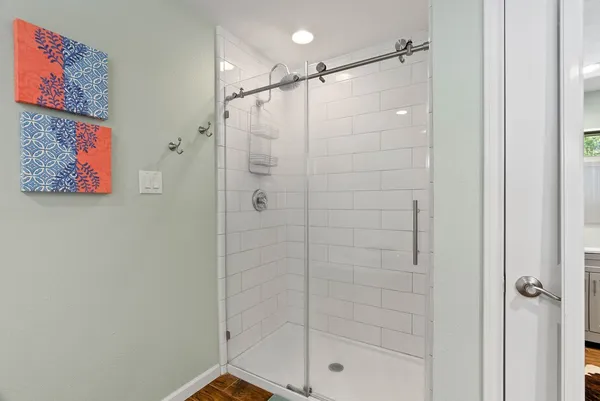 a bathroom with a shower and a sink