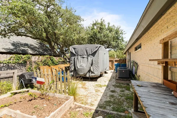 a view of roof deck with table and chairs a barbeque with wooden floor and fence