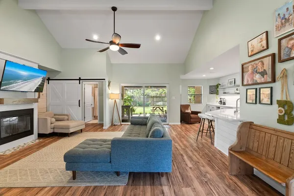 a living room with furniture fireplace and flat screen tv
