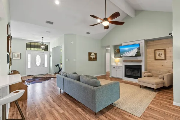 a living room with furniture and a fireplace